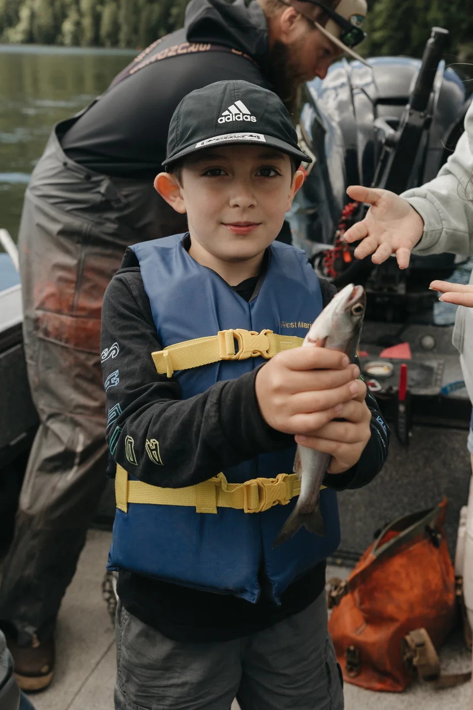 Young participant holding a freshly caught fish