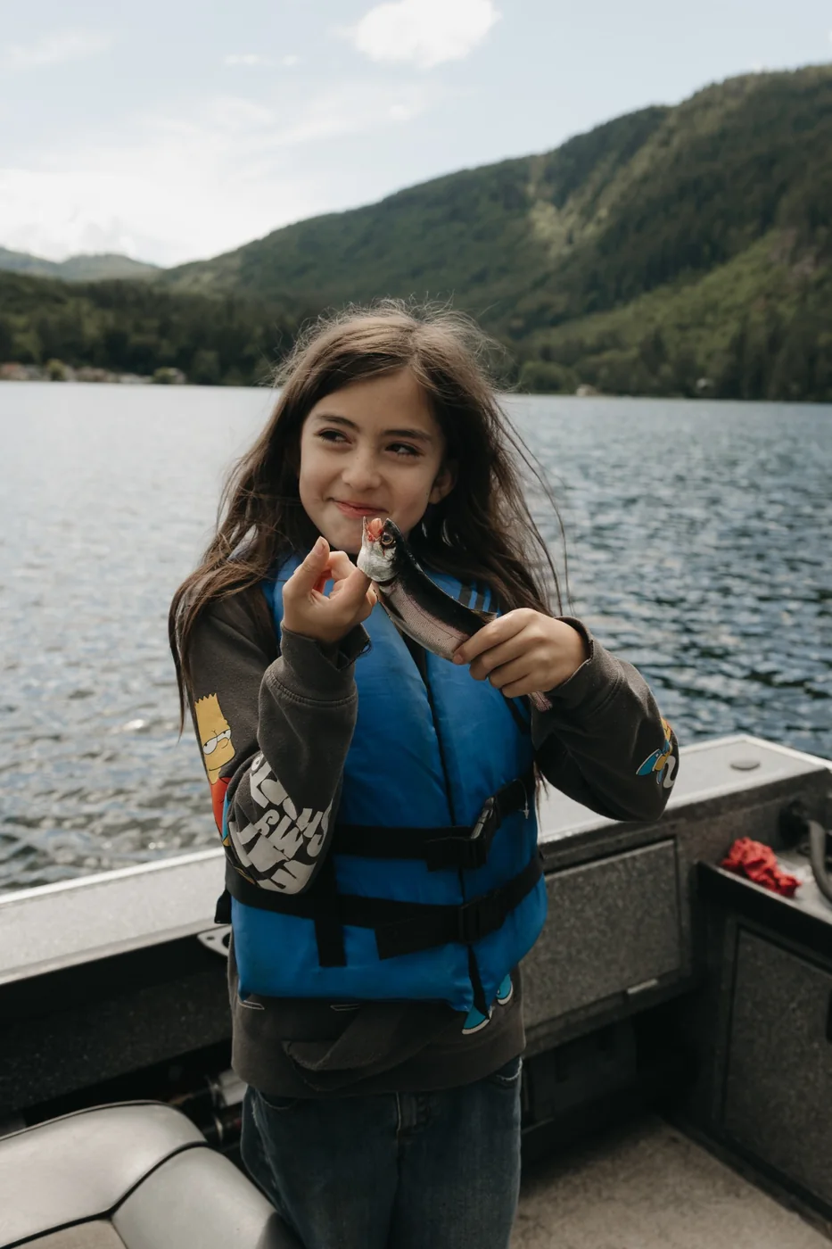Young participant proudly holding a fish she caught